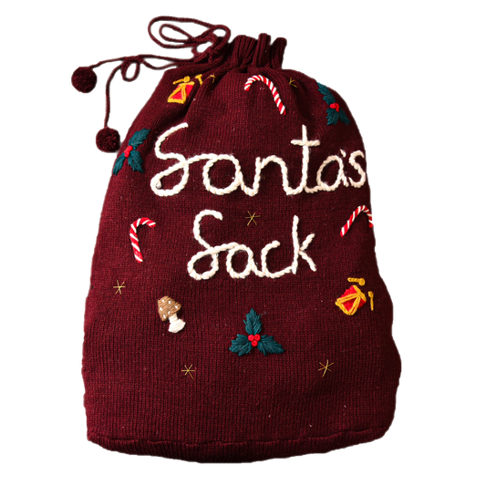 Close-up of a red wool Santa sack with the words "Santa's Sack" embroidered on the front.