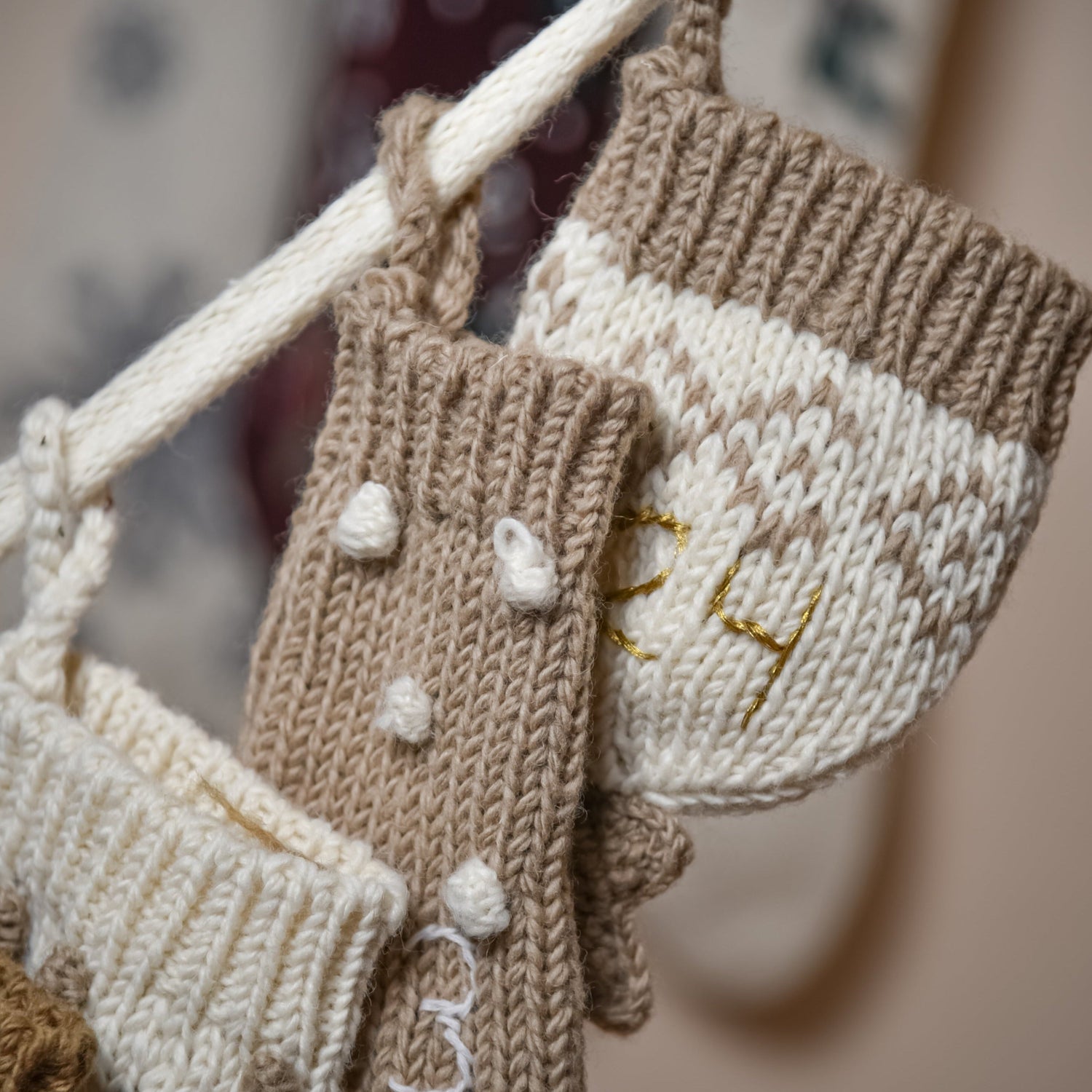 Close-up of a section of the cream wool Advent Calendar, showing the details of the handcrafted design and embroidered numbers.