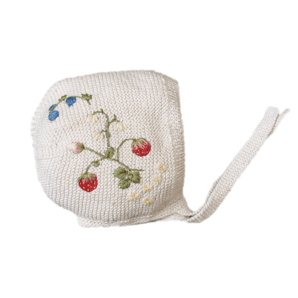 White knitted bonnet with embroidered strawberries, flowers and blue buds
