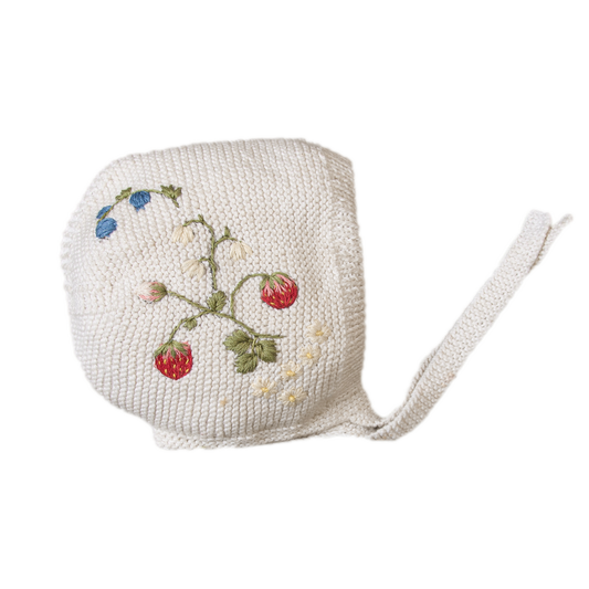 White knitted bonnet with embroidered strawberries, flowers and blue buds