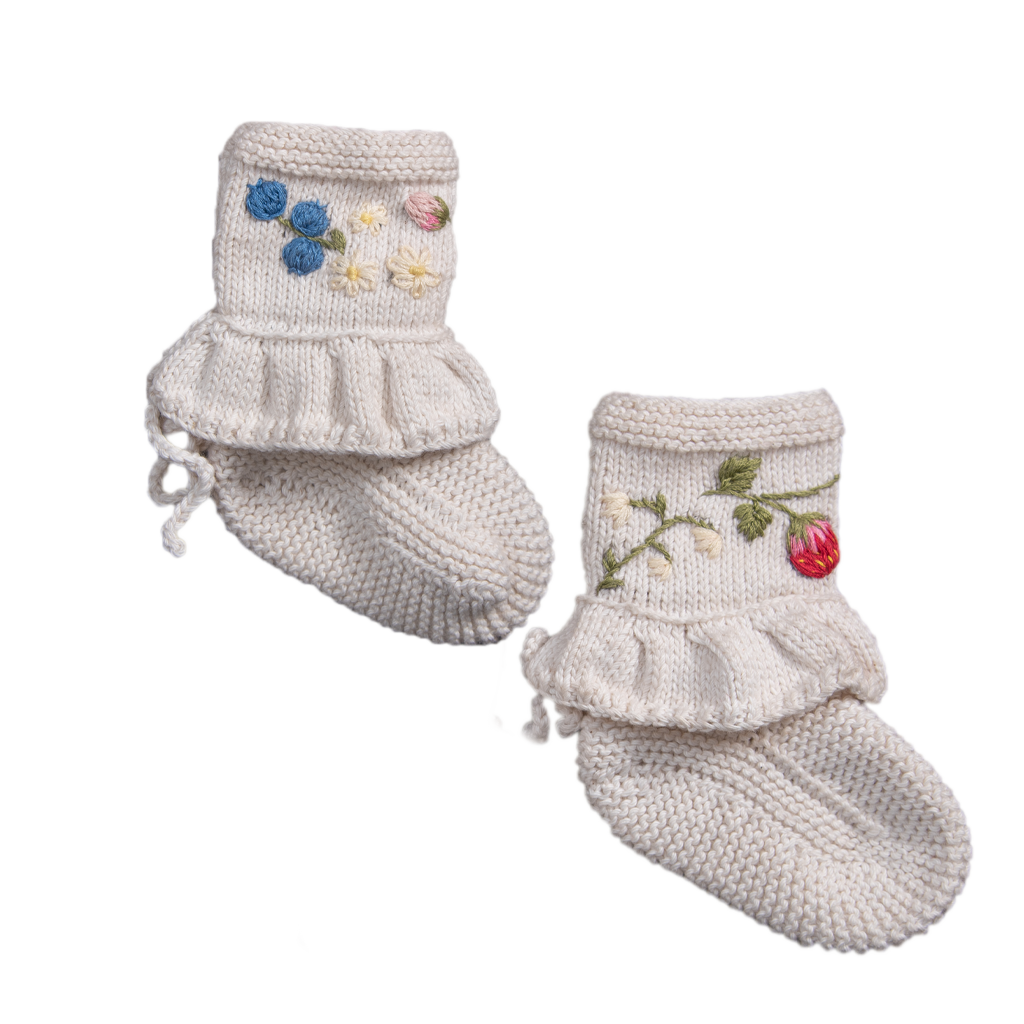 Handcrafted baby booties made from soft knit cotton, adorned with delicate embroidered berries and florals.
