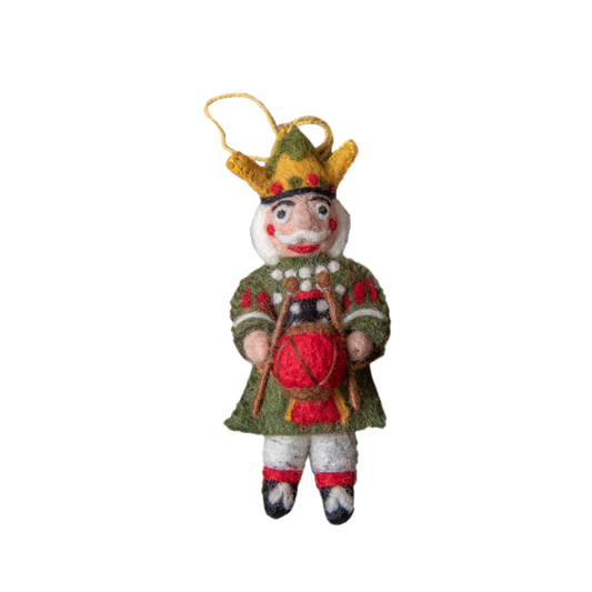 Nutcracker ornament in green with intricate embroidery and whimsical details