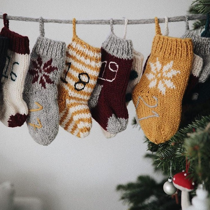 Handcrafted Christmas stockings displayed with festive designs.