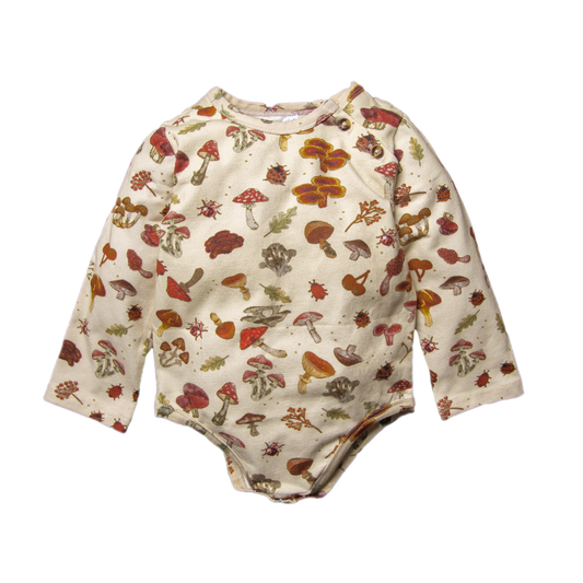 A cream long-sleeve baby bodysuit decorated with a whimsical mushroom print.