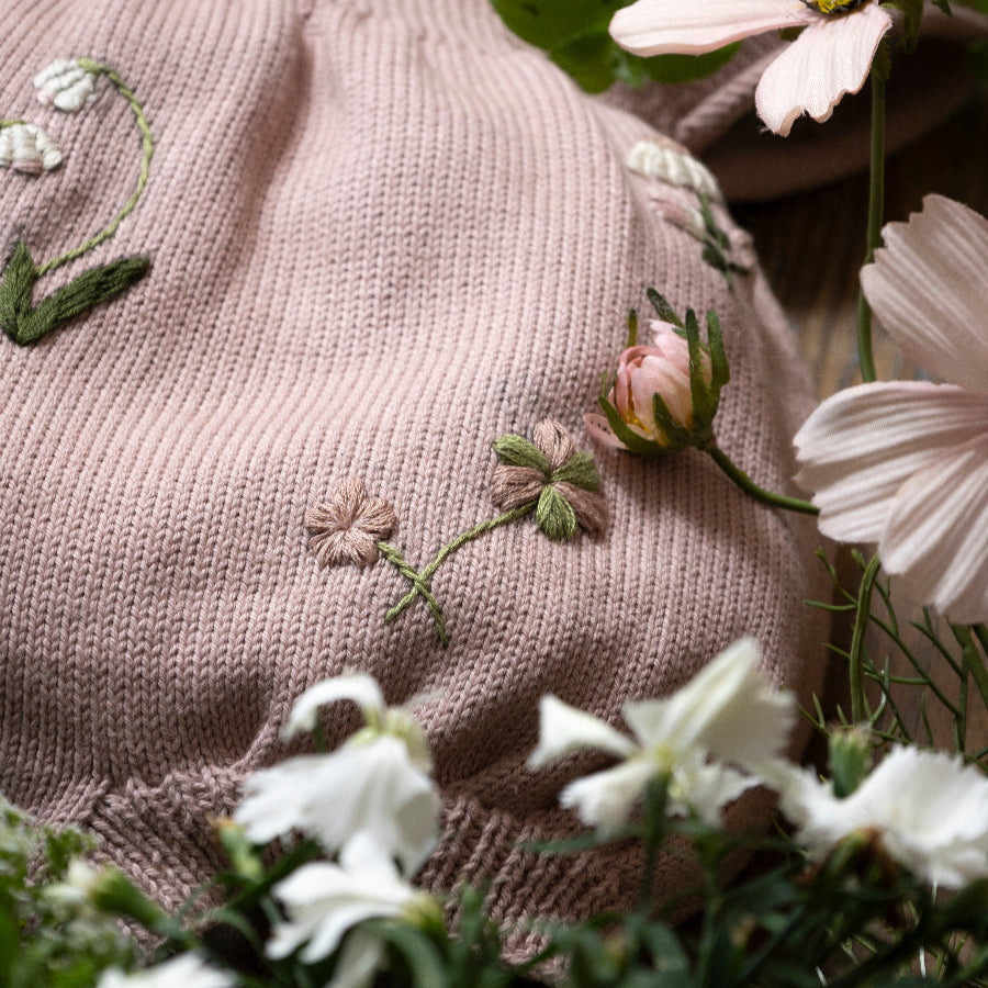 dahlia knitted botanical romper for babies